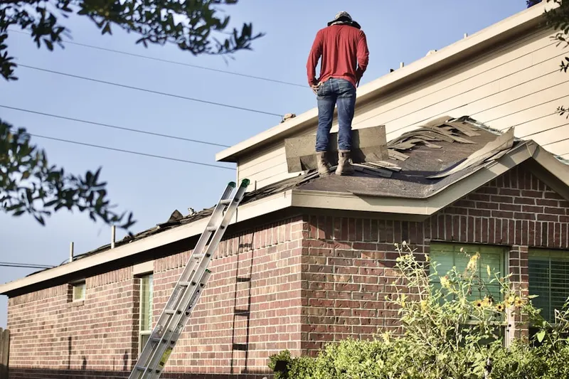 Professional roofer working on a residential roof in North Ridge at Mansfield